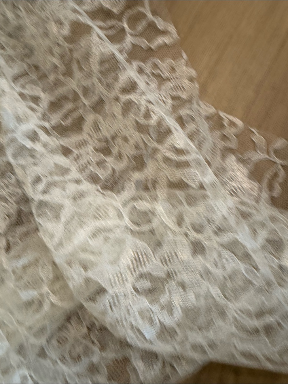 Ivory floral lace fabric with a scalloped edge